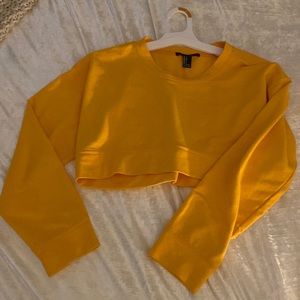 A cropped mustard yellow sweater
